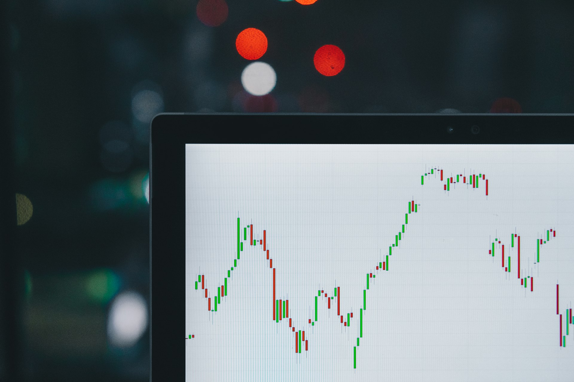 Laptop candlestick chart — a desk product, not a TradingView overlay